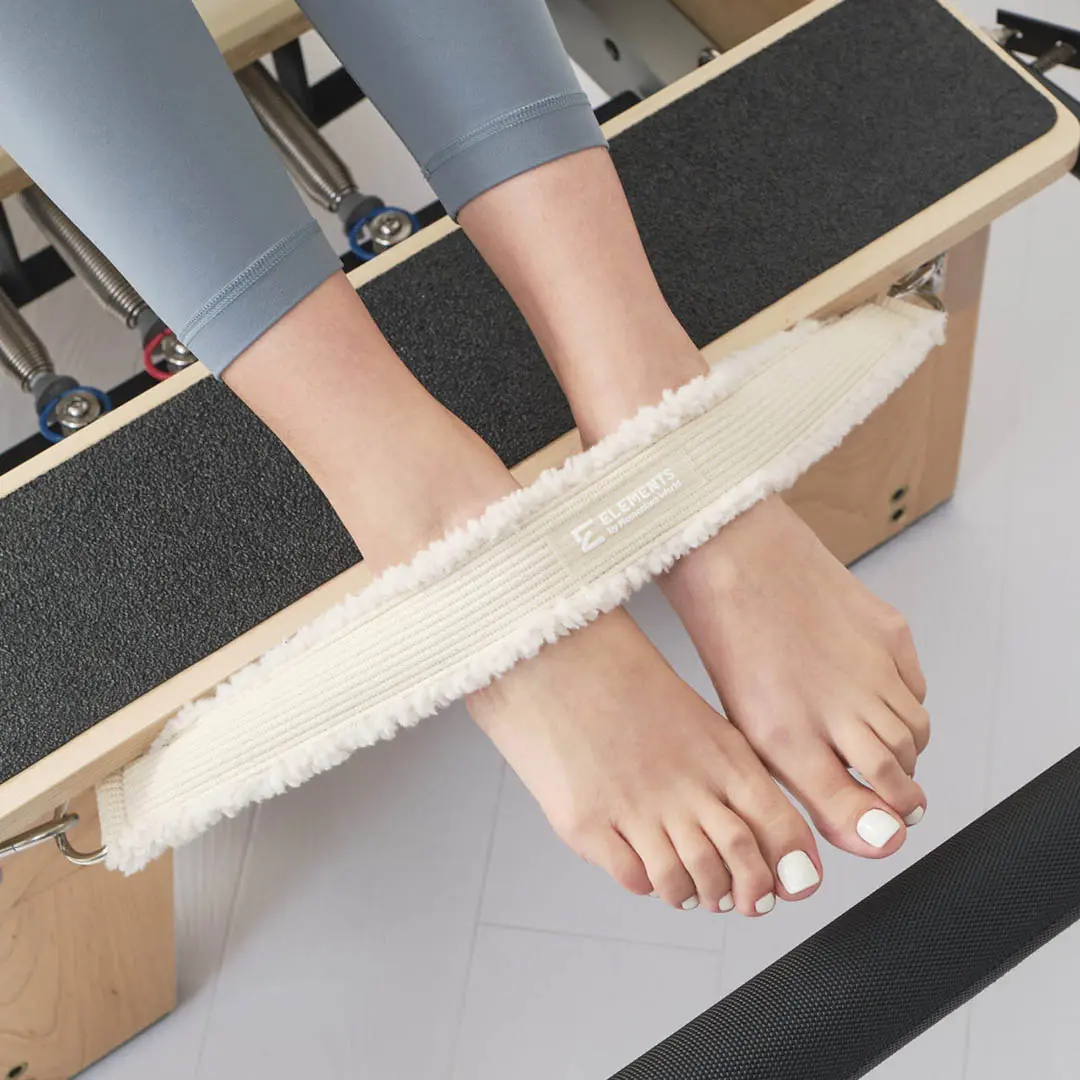 ELEMENTS Reformer Cadillac Foot Strap Reformer safety foot strap ivory faux fur in use