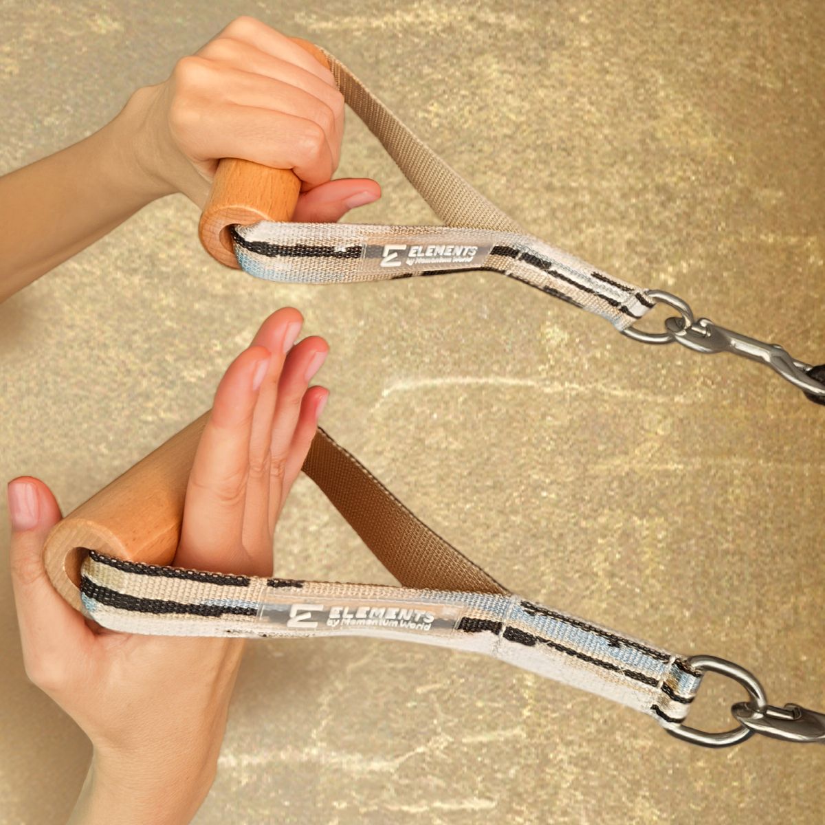 ELEMENTS® Wooden Roll Handles in use in the hands on a pilates reformer in front of a golden wall