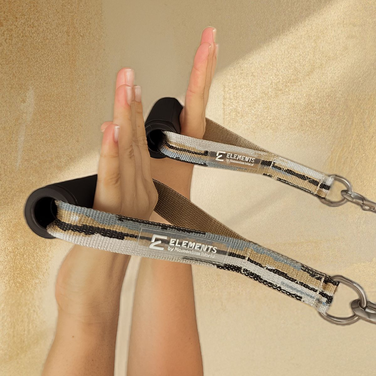 ELEMENTS® Roll Handles in Mirage Gold shown in use in the hands